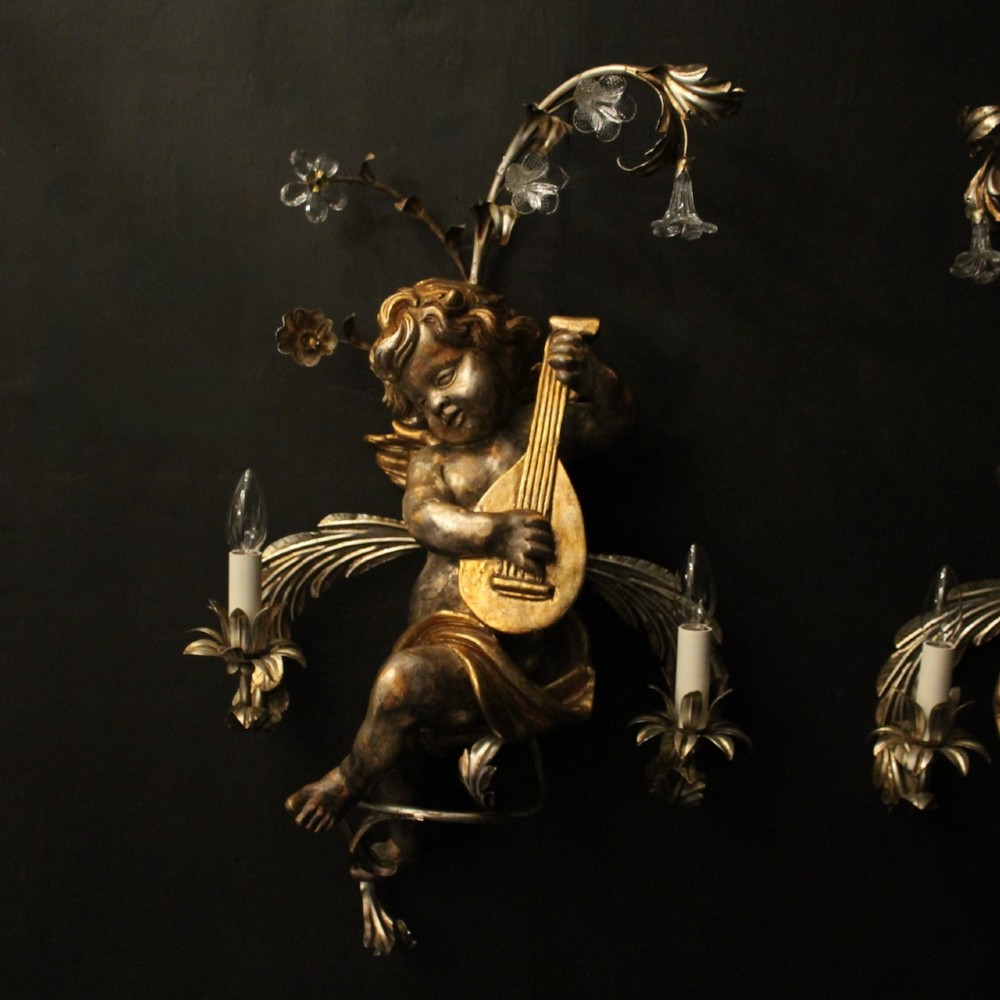 Pair of Italian giltwood wall sconces featuring sculpted cherubs playing musical instruments framed by metal branches with clear glass flowers. View II