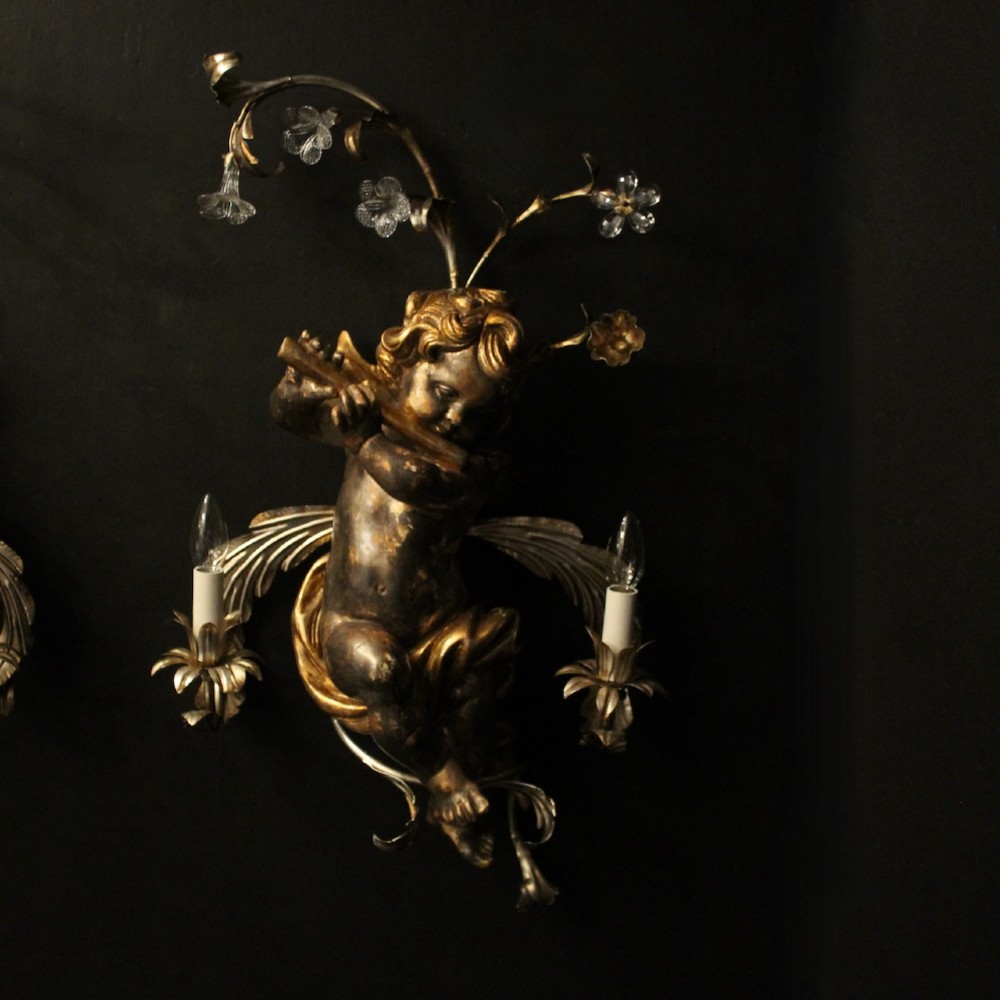 Pair of Italian giltwood wall sconces featuring sculpted cherubs playing musical instruments framed by metal branches with clear glass flowers. View III