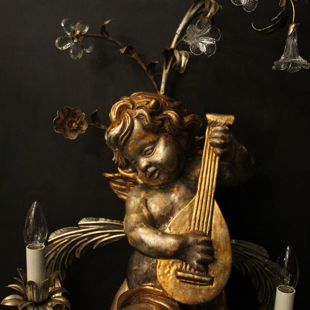 Pair of Italian giltwood wall sconces featuring sculpted cherubs playing musical instruments framed by metal branches with clear glass flowers. View IV