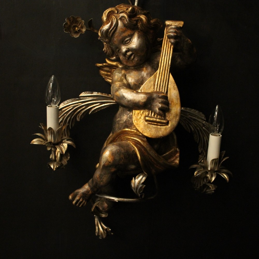 Pair of Italian giltwood wall sconces featuring sculpted cherubs playing musical instruments framed by metal branches with clear glass flowers. View V