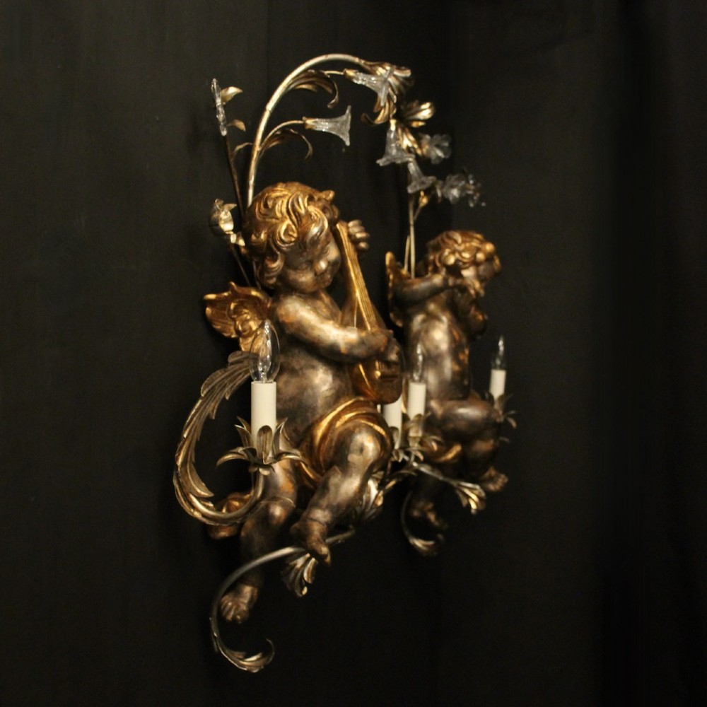 Pair of Italian giltwood wall sconces featuring sculpted cherubs playing musical instruments framed by metal branches with clear glass flowers. View IX