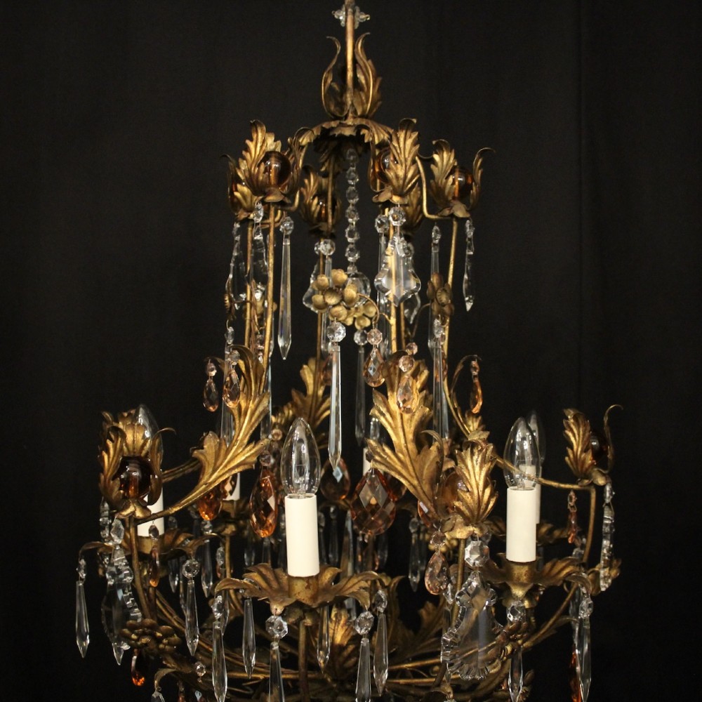 A six-light Florentine chandelier crafted with a gilded leaf metal frame and decorated with suspended clear and amber glass crystal droplets. View III