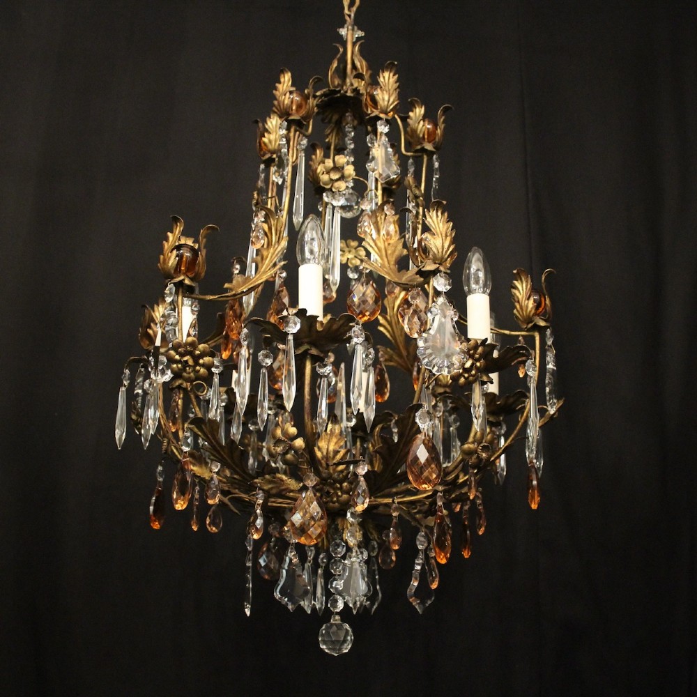 A six-light Florentine chandelier crafted with a gilded leaf metal frame and decorated with suspended clear and amber glass crystal droplets. View IV