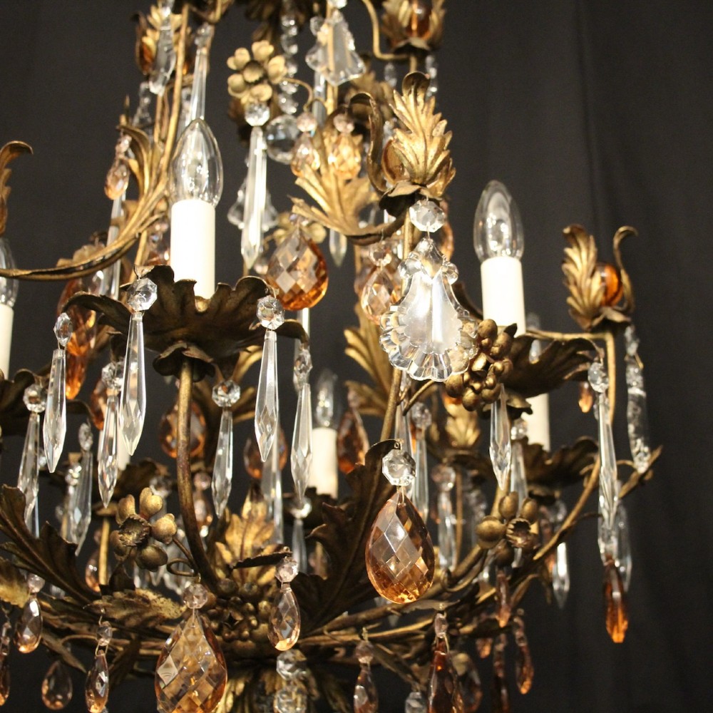 A six-light Florentine chandelier crafted with a gilded leaf metal frame and decorated with suspended clear and amber glass crystal droplets. View VII