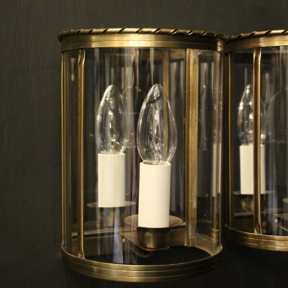A pair of French brass convex half lanterns with curved glass panels and twin candle bulb sockets. View III