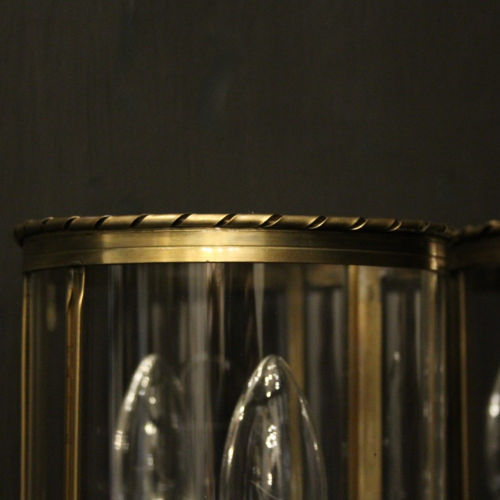 A pair of French brass convex half lanterns with curved glass panels and twin candle bulb sockets. View VII