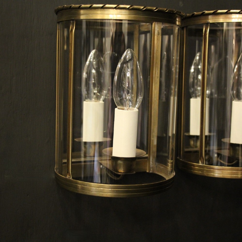 A pair of French brass convex half lanterns with curved glass panels and twin candle bulb sockets. View VIII