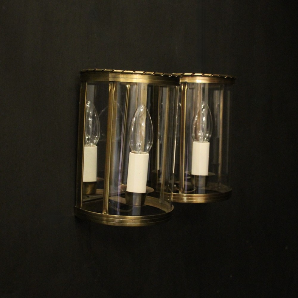 A pair of French brass convex half lanterns with curved glass panels and twin candle bulb sockets. View X