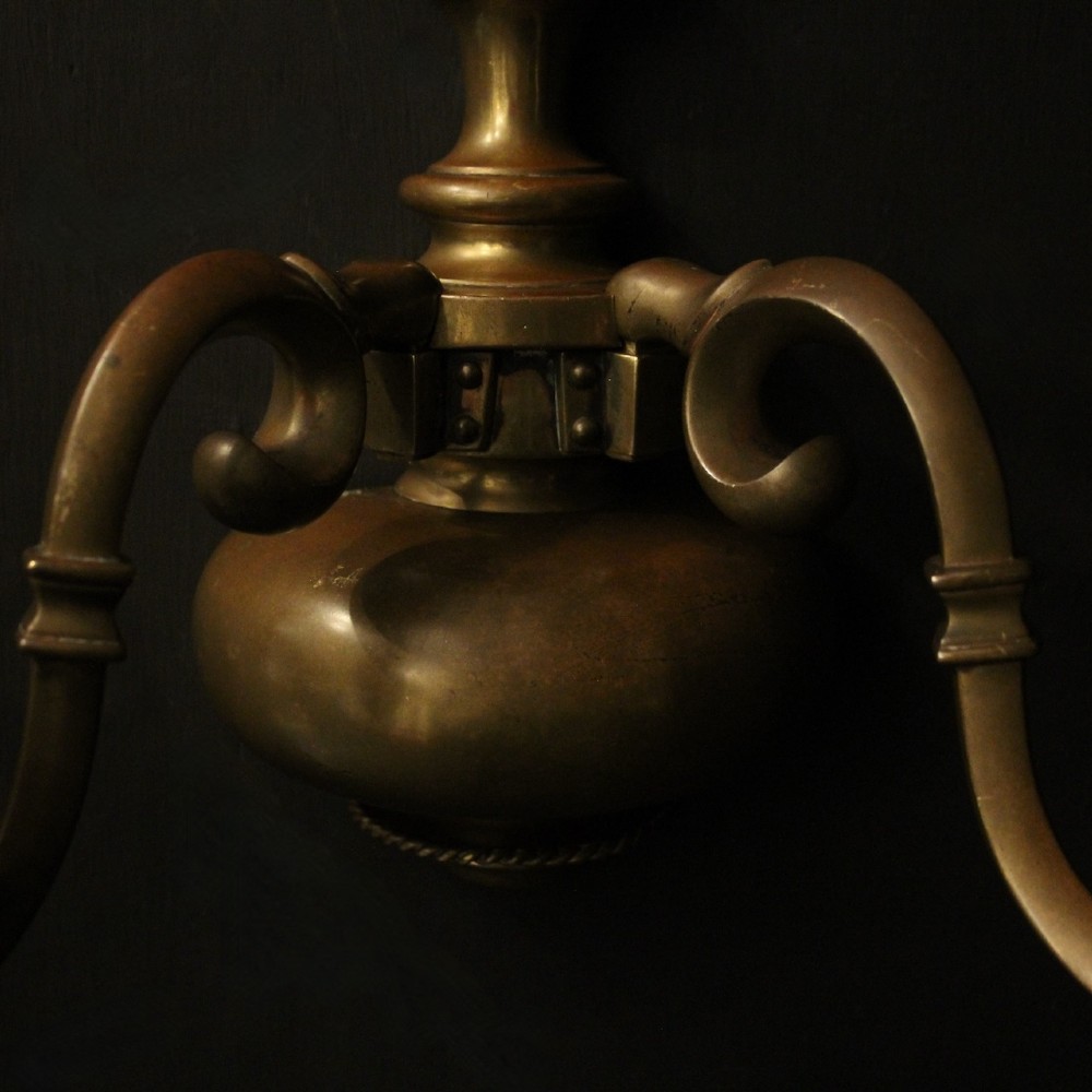 A set of three antique bronze wall sconces, each featuring a turned central baluster and two scrolled arms holding candle-style bulb holders. View V