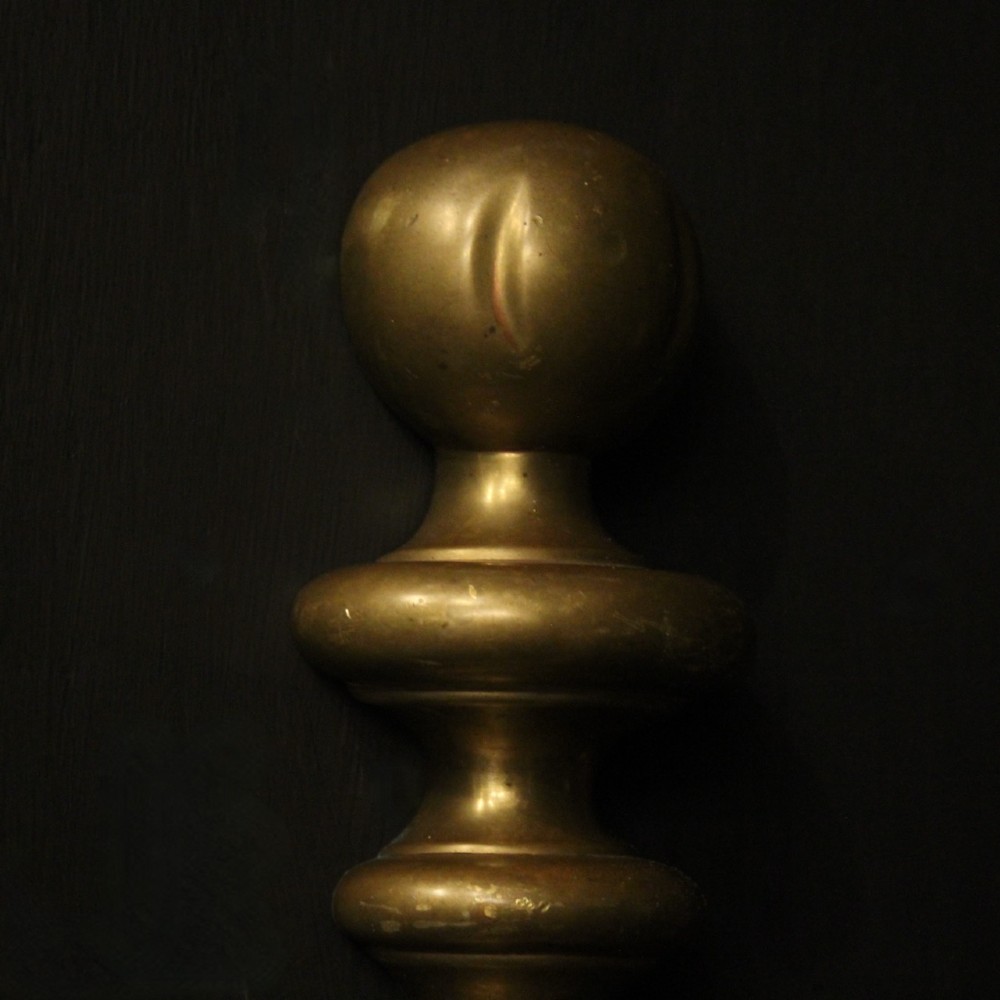 A pair of antique bronze single-arm wall lights with turned baluster shafts and candle-style fittings against a dark background. View IX