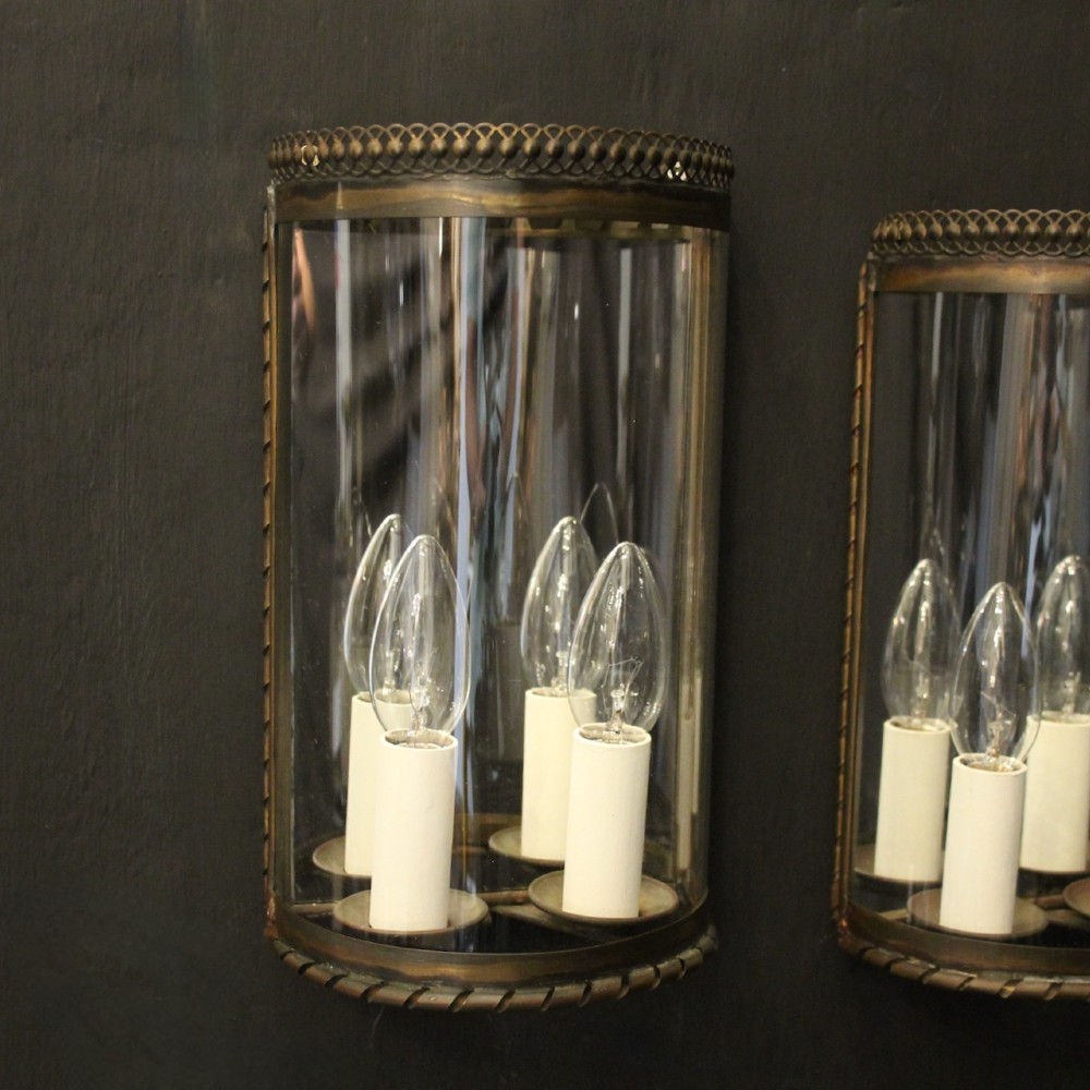 A pair of semi-circular brass half-lantern wall sconces featuring curved clear glass panels and four faux candle-bulb fittings inside each unit. View III