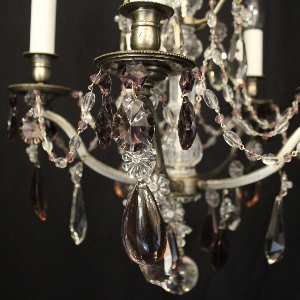 An antique French silver gilt five-light chandelier with clear and tinted crystal teardrop pendants, bead strands, and candle-style bulb sockets. View VI