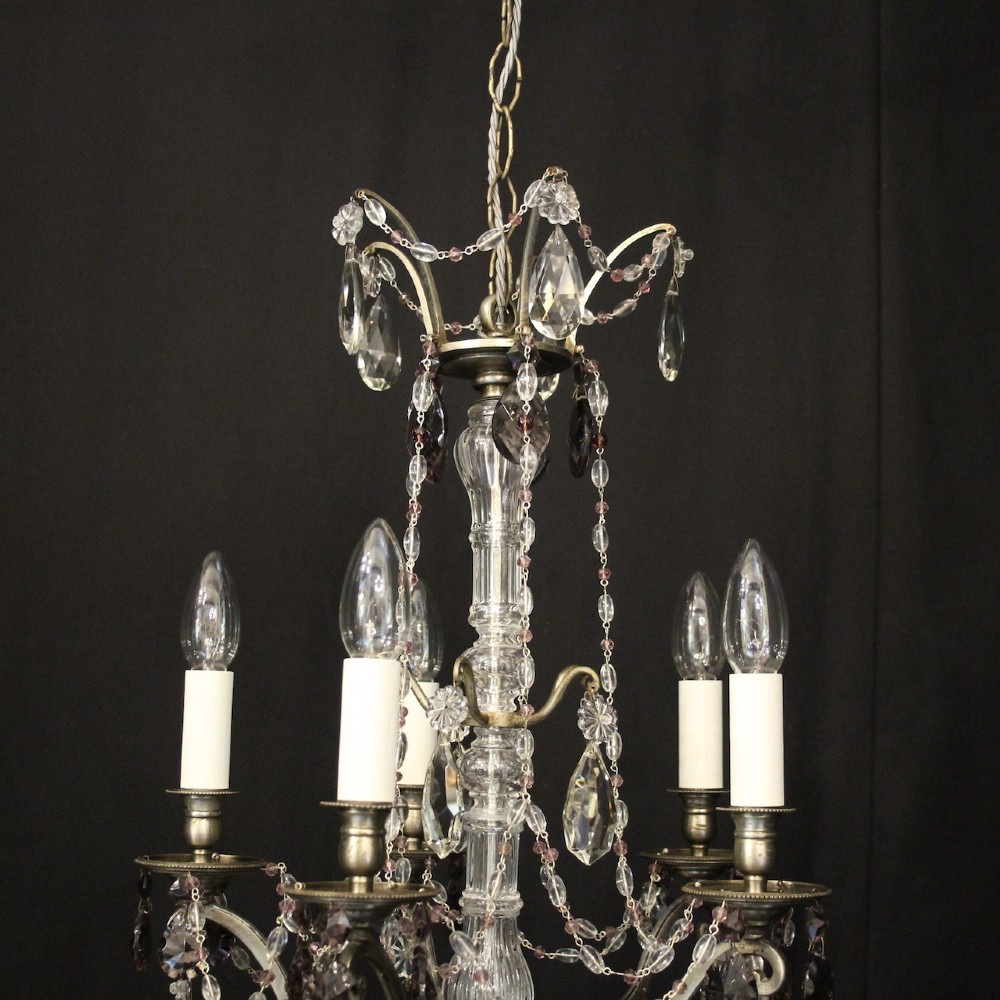 An antique French silver gilt five-light chandelier with clear and tinted crystal teardrop pendants, bead strands, and candle-style bulb sockets. View IX