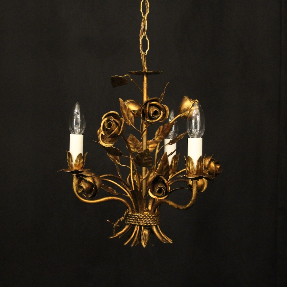 A French gilt metal triple-light chandelier styled with hand-formed metal rose blossoms, leaves, and a tied sheaf motif at the base.
