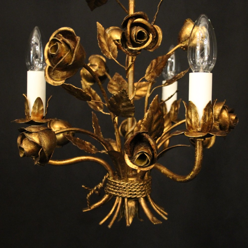 A French gilt metal triple-light chandelier styled with hand-formed metal rose blossoms, leaves, and a tied sheaf motif at the base. View VII