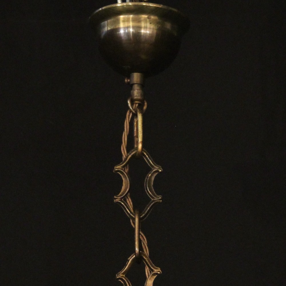 An English brass hall lantern featuring curved convex glass panels and four candle-style light sockets suspended from a central stem. View X