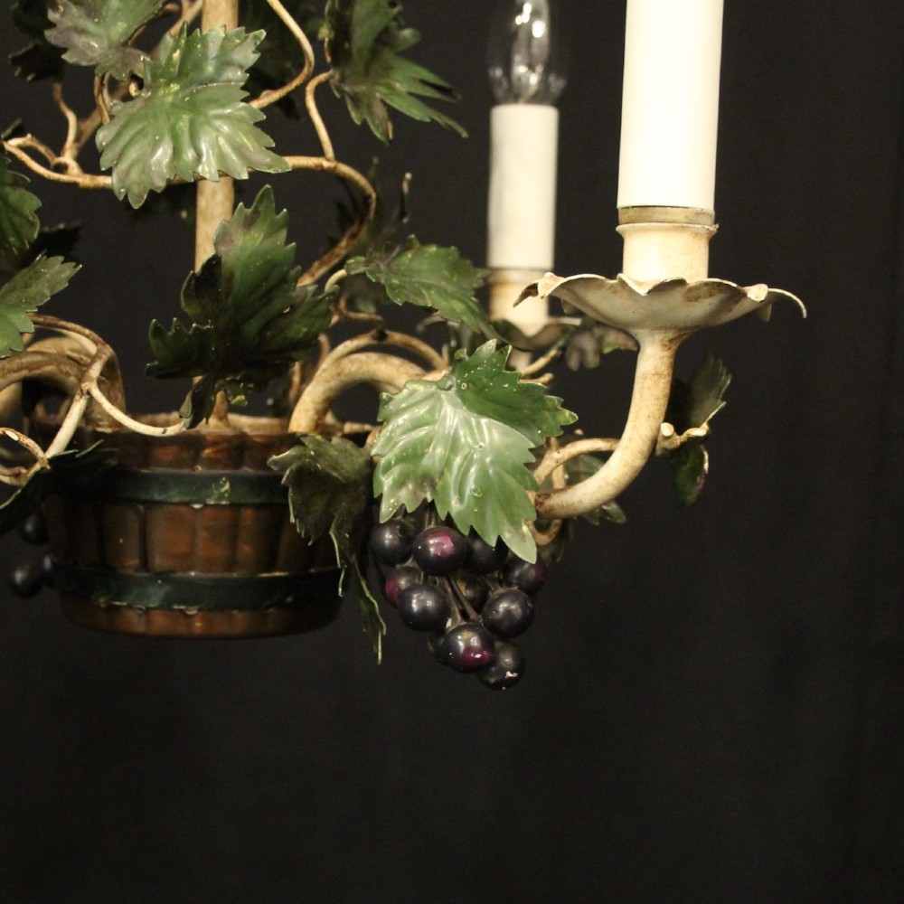 A French toleware four-light chandelier featuring cream candle sleeves, hand-painted green vine leaves, and dark grape clusters surrounding a central stem. View II