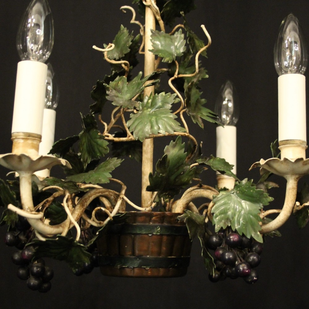 A French toleware four-light chandelier featuring cream candle sleeves, hand-painted green vine leaves, and dark grape clusters surrounding a central stem. View V
