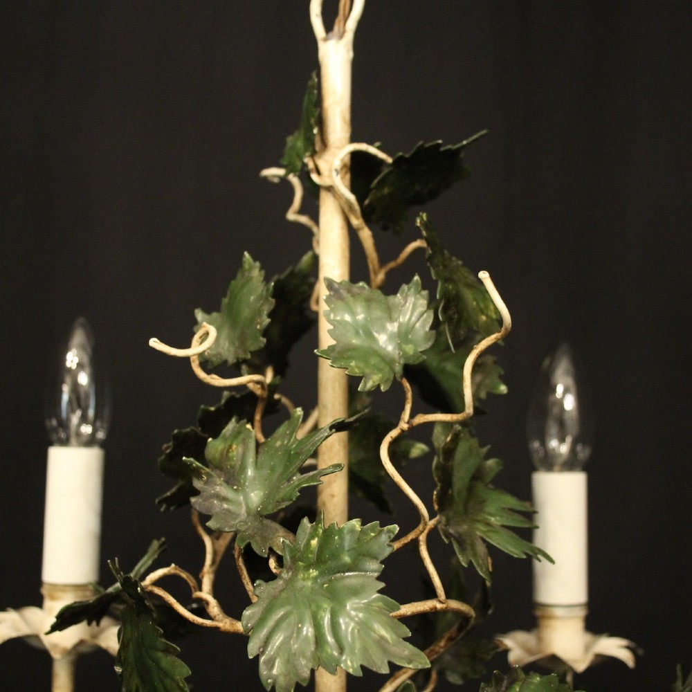 A French toleware four-light chandelier featuring cream candle sleeves, hand-painted green vine leaves, and dark grape clusters surrounding a central stem. View VIII