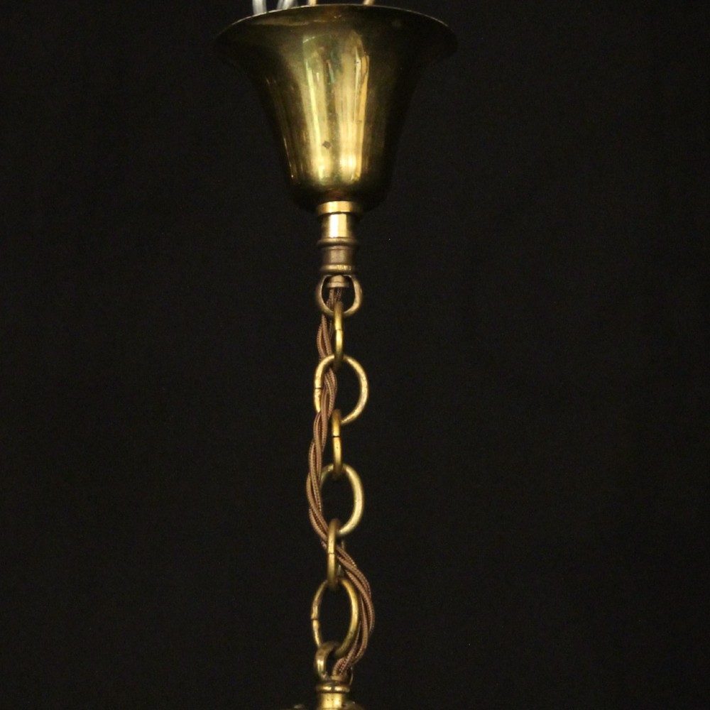 A French gilded brass hall lantern featuring a cylindrical glass shade enclosing three candle-style bulb holders suspended by an arched frame. View X