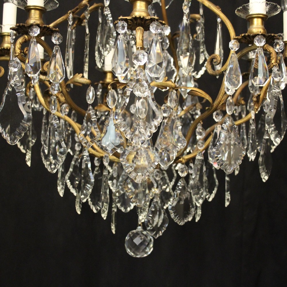 A ten-light French gilded metal chandelier featuring cascading cut-crystal glass drops and candle-style light sockets. View VII
