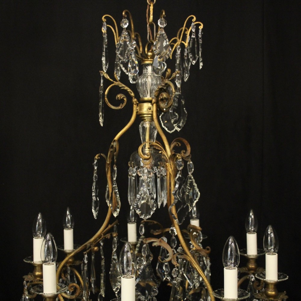 A ten-light French gilded metal chandelier featuring cascading cut-crystal glass drops and candle-style light sockets. View VIII