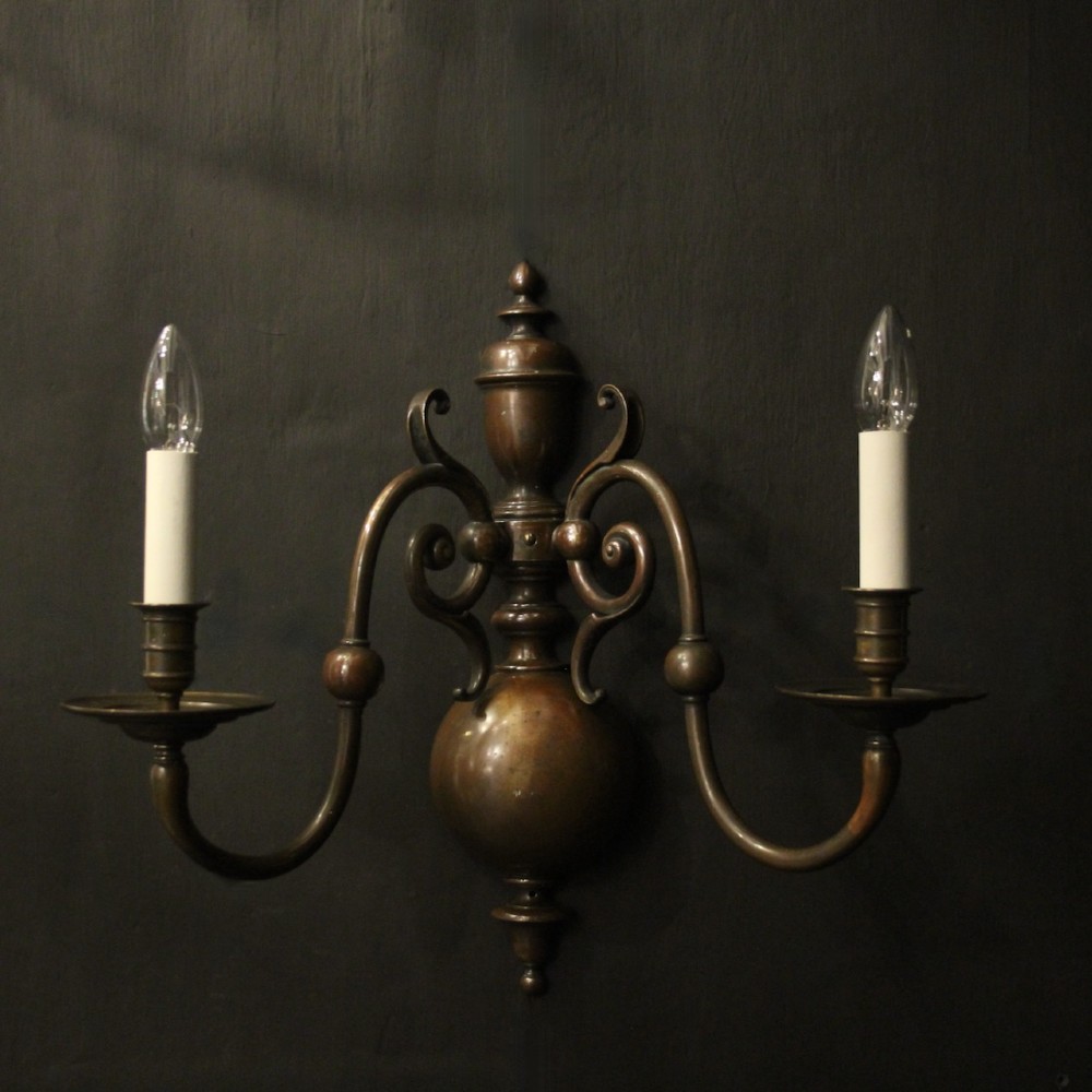 A pair of dark bronze twin-arm wall sconces featuring turned central shafts, scrollwork accents, and candle-style fittings. View II