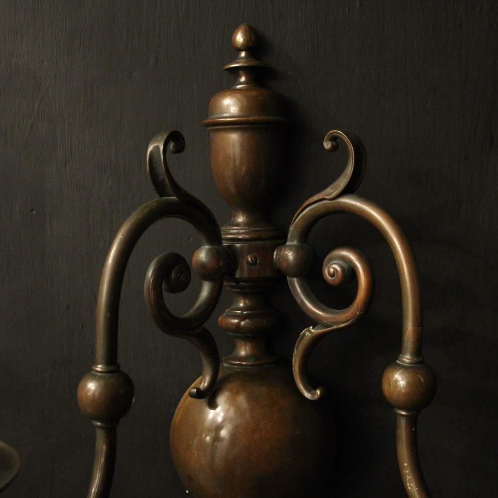 A pair of dark bronze twin-arm wall sconces featuring turned central shafts, scrollwork accents, and candle-style fittings. View V