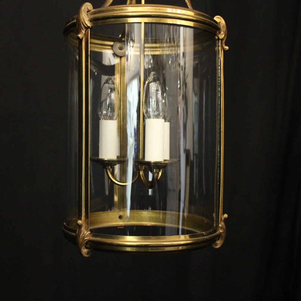 A cylindrical French hall lantern with a gilt brass frame, convex glass panels, and an internal three-light candelabra fitting suspended by a ring. View III