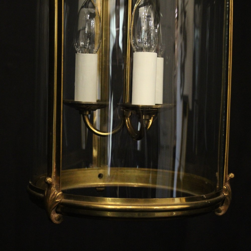 A cylindrical French hall lantern with a gilt brass frame, convex glass panels, and an internal three-light candelabra fitting suspended by a ring. View VIII