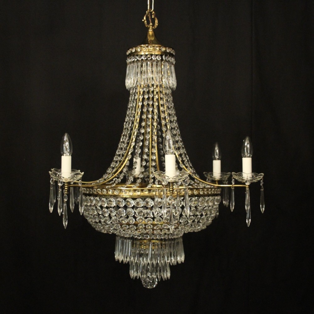 A French gilded brass nine-light chandelier featuring a cascading tent and waterfall structure adorned with faceted crystal beads and drops.