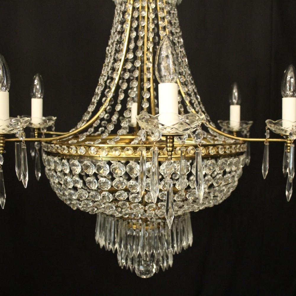 A French gilded brass nine-light chandelier featuring a cascading tent and waterfall structure adorned with faceted crystal beads and drops. View II