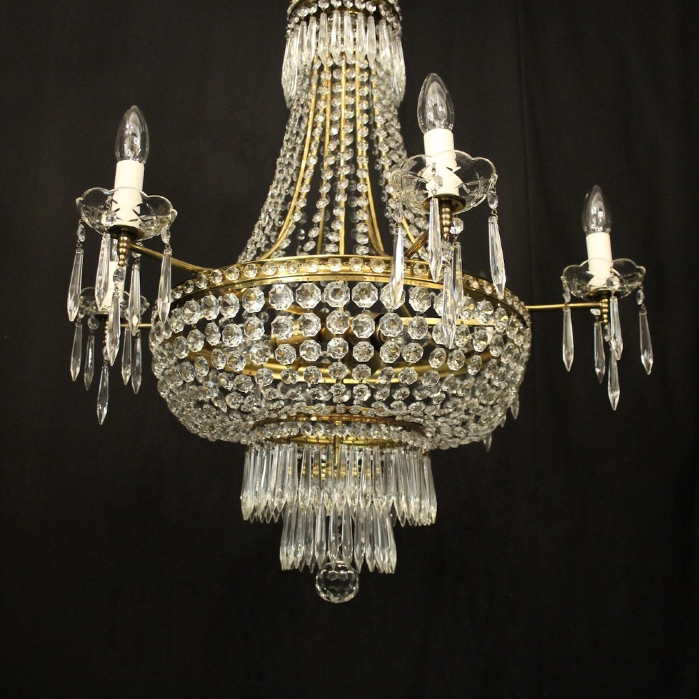 A French gilded brass nine-light chandelier featuring a cascading tent and waterfall structure adorned with faceted crystal beads and drops. View IV