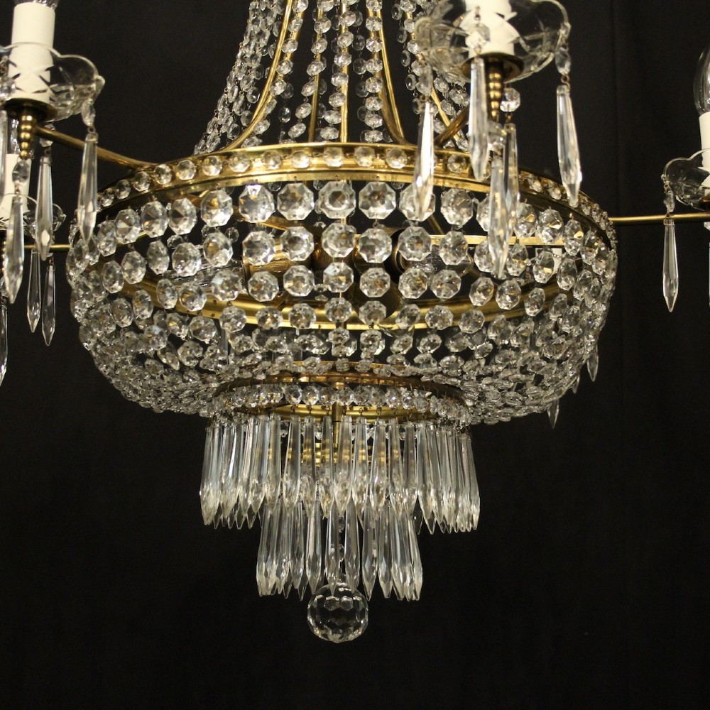 A French gilded brass nine-light chandelier featuring a cascading tent and waterfall structure adorned with faceted crystal beads and drops. View V