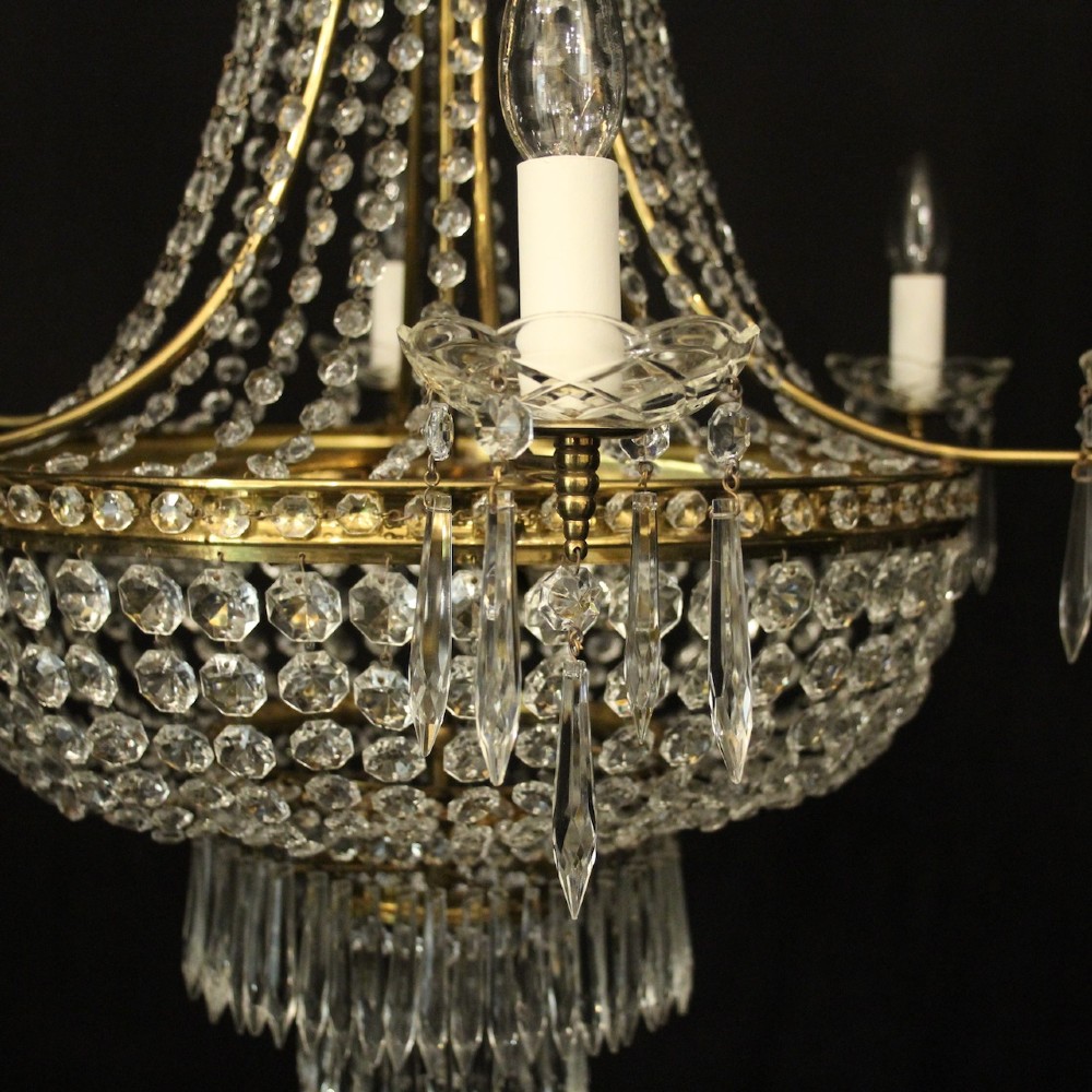A French gilded brass nine-light chandelier featuring a cascading tent and waterfall structure adorned with faceted crystal beads and drops. View VI