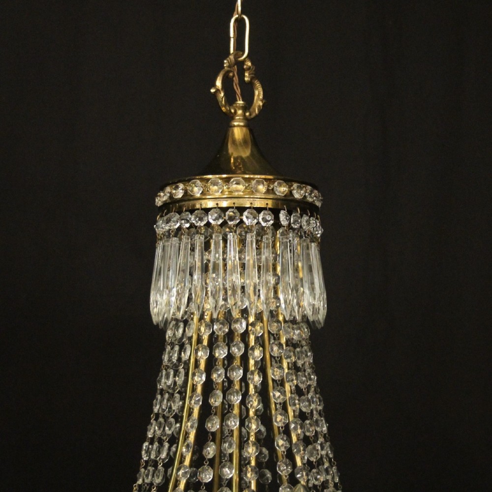 A French gilded brass nine-light chandelier featuring a cascading tent and waterfall structure adorned with faceted crystal beads and drops. View IX