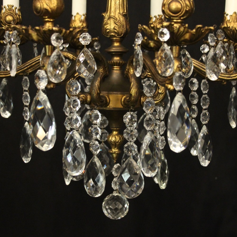 An eight-light antique French chandelier crafted from gilded metal featuring scrolling arms and clear cut glass crystal drops. View VI