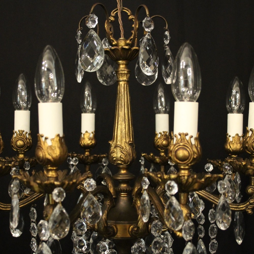 An eight-light antique French chandelier crafted from gilded metal featuring scrolling arms and clear cut glass crystal drops. View VII