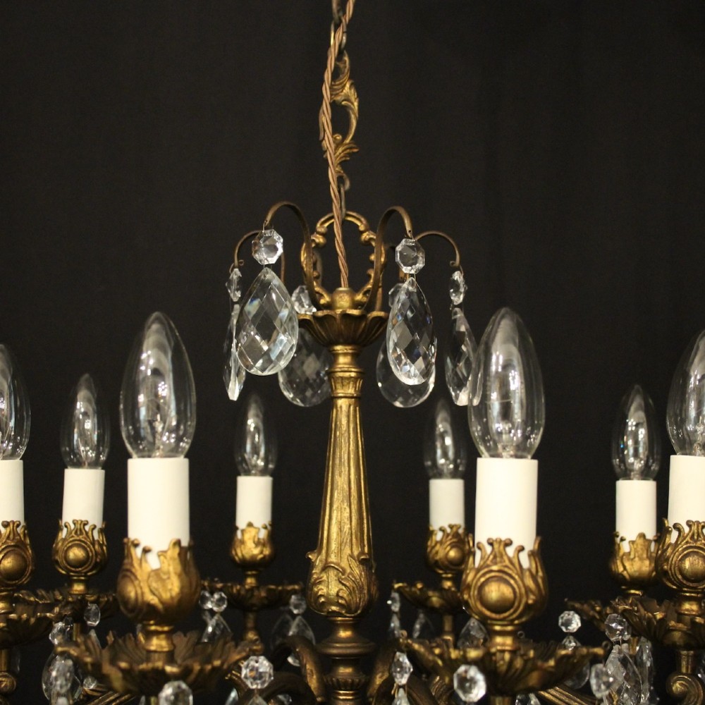 An eight-light antique French chandelier crafted from gilded metal featuring scrolling arms and clear cut glass crystal drops. View VIII