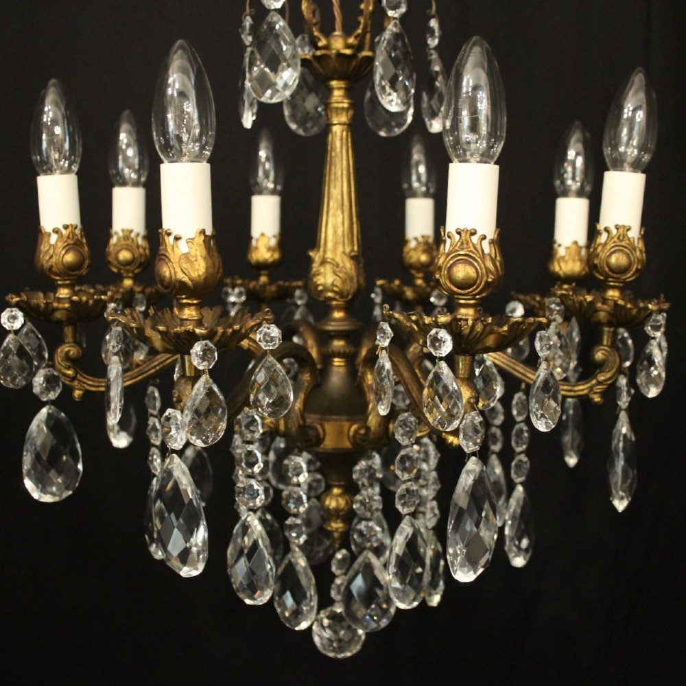 An eight-light antique French chandelier crafted from gilded metal featuring scrolling arms and clear cut glass crystal drops. View IX