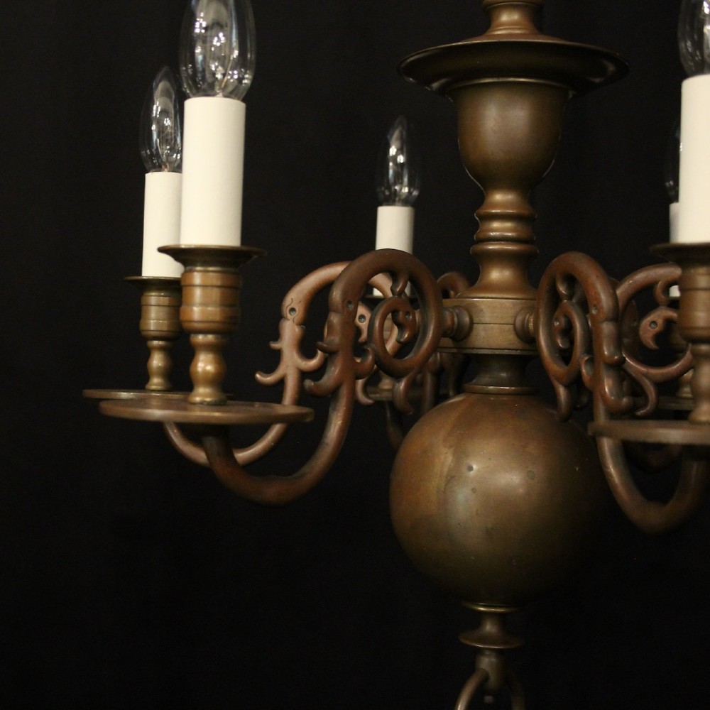 A pair of dark bronze six-light chandeliers featuring central turned baluster stems, lower spherical drops, and scrolling candle arms. View IV