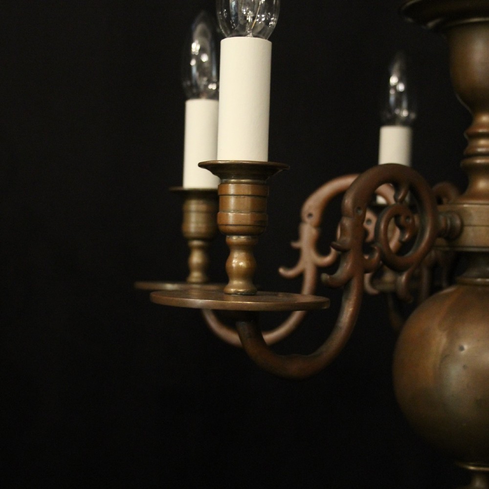 A pair of dark bronze six-light chandeliers featuring central turned baluster stems, lower spherical drops, and scrolling candle arms. View V