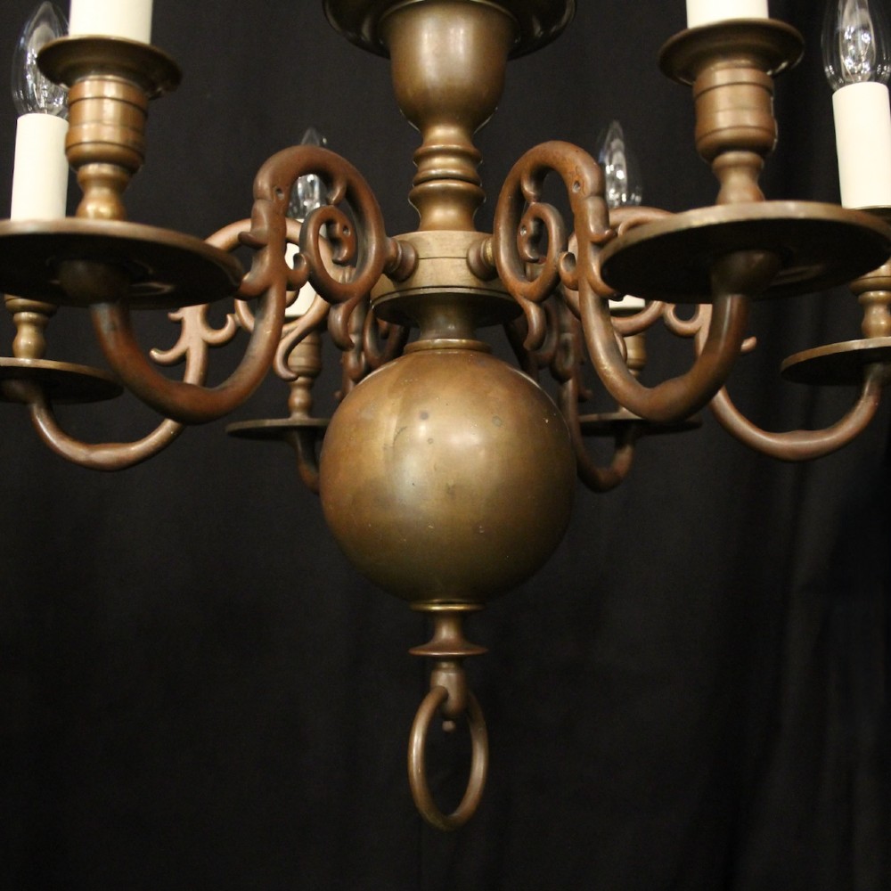 A pair of dark bronze six-light chandeliers featuring central turned baluster stems, lower spherical drops, and scrolling candle arms. View VI