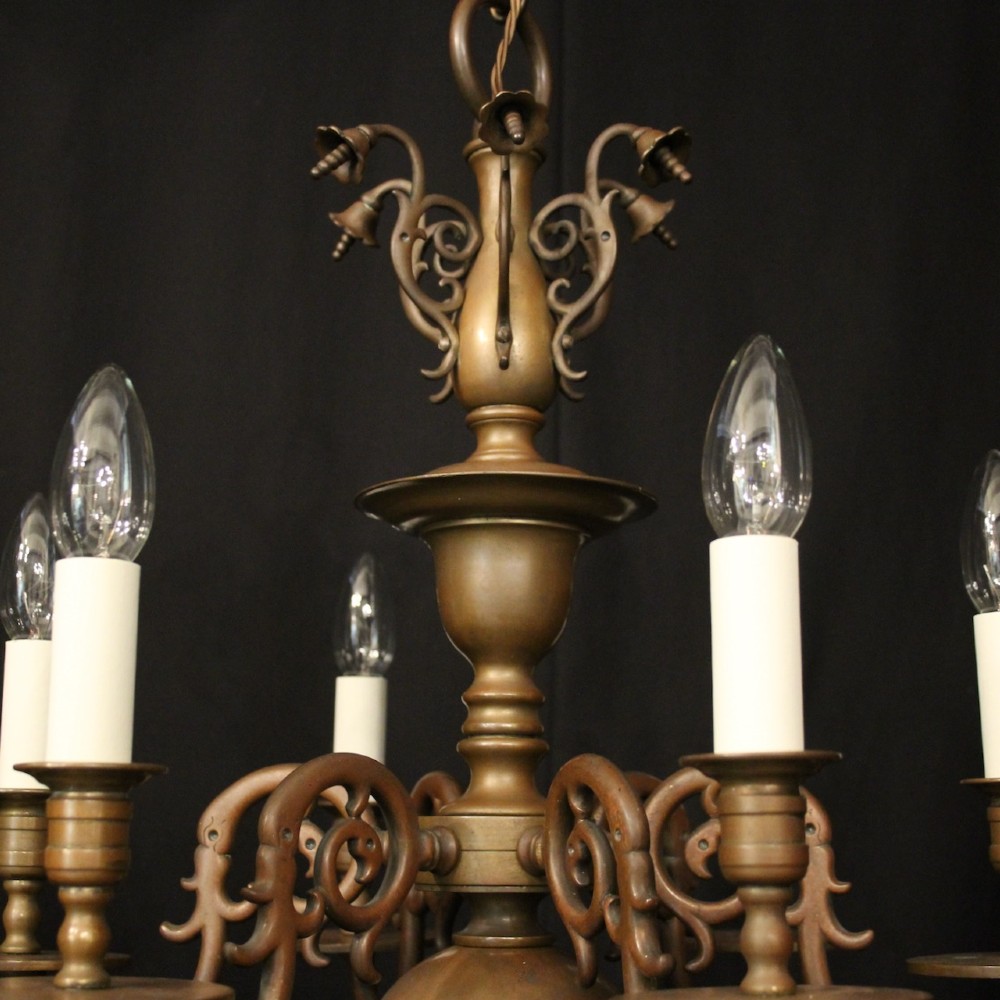 A pair of dark bronze six-light chandeliers featuring central turned baluster stems, lower spherical drops, and scrolling candle arms. View VIII