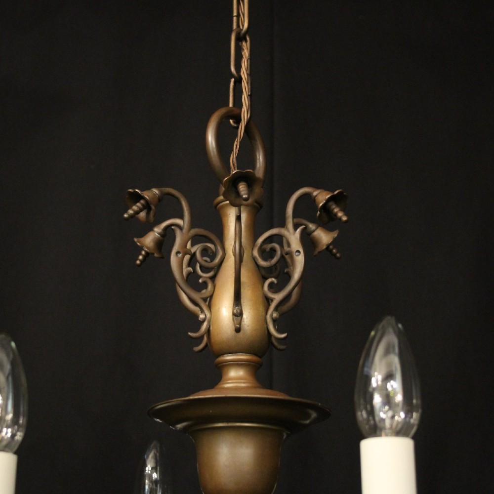 A pair of dark bronze six-light chandeliers featuring central turned baluster stems, lower spherical drops, and scrolling candle arms. View IX