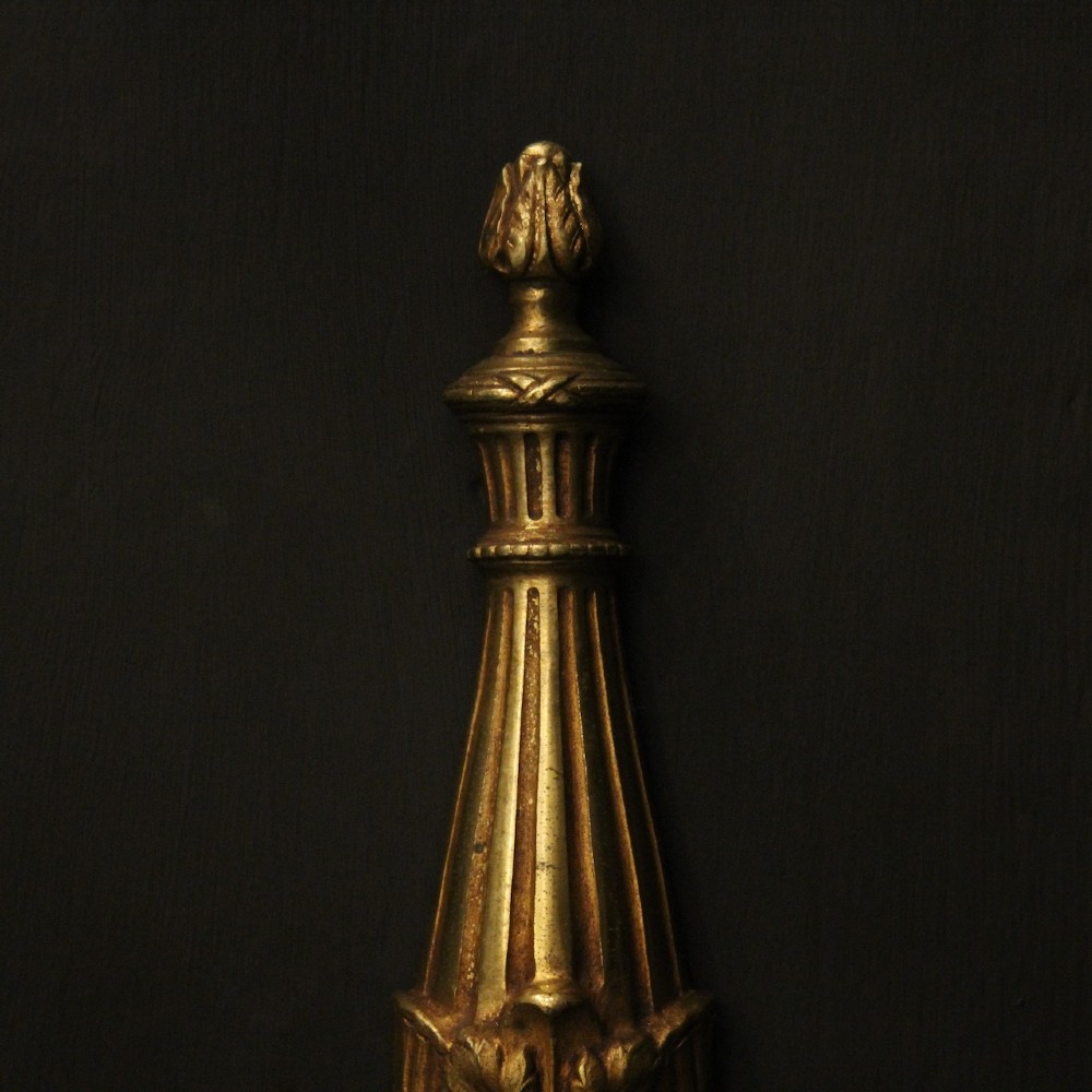 A pair of French Neoclassical gilded bronze twin-arm wall lights with acanthus leaf motifs, central fluted columns, and candle-style fittings. View V