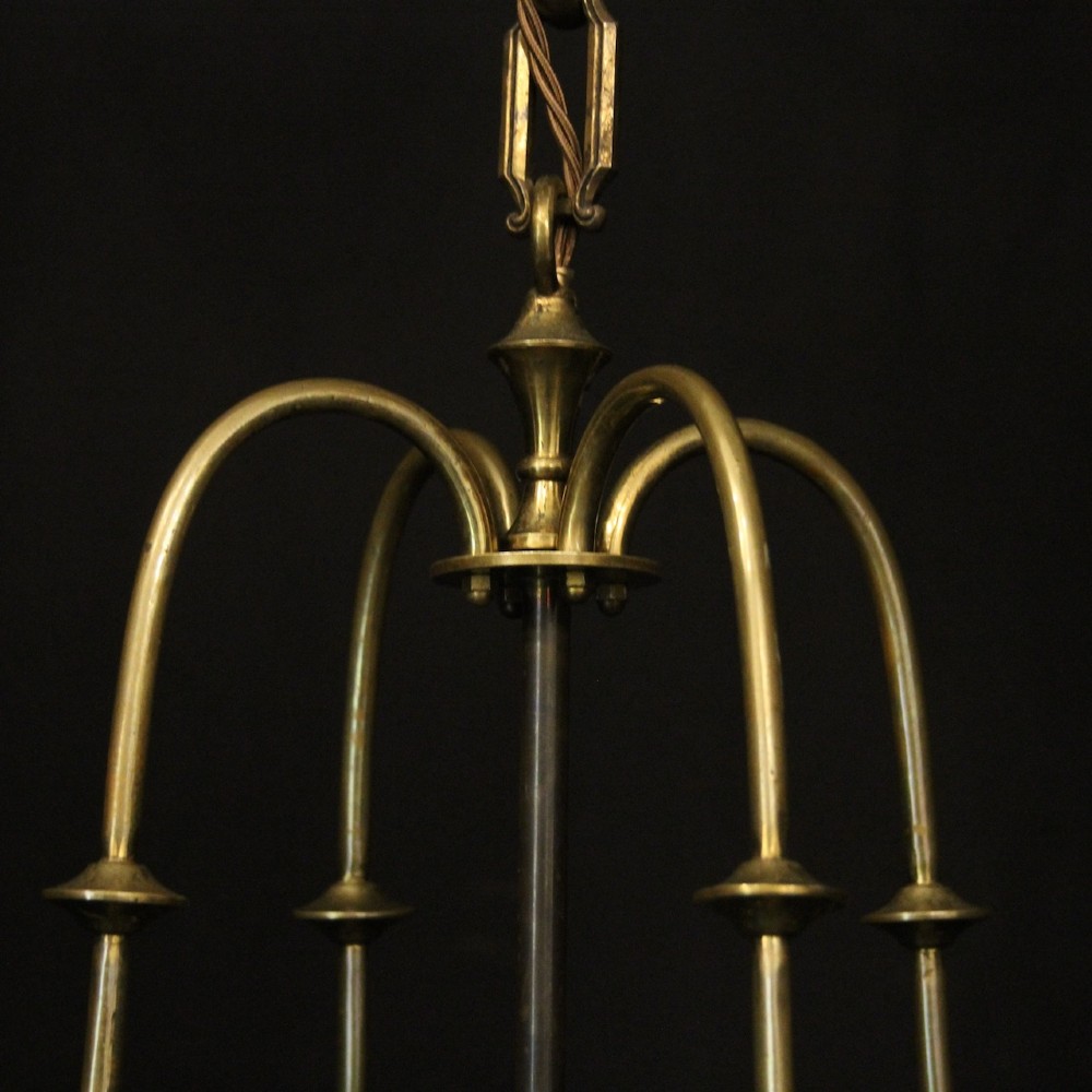 A hanging gilt brass hall lantern featuring curved convex glass panels and an internal four-candle light cluster supported by a central chain. View VII