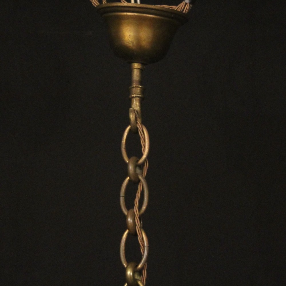 A cylindrical gilded bronze hall lantern with curved clear glass panels and four internal candle bulb fittings hanging from a chain. View X
