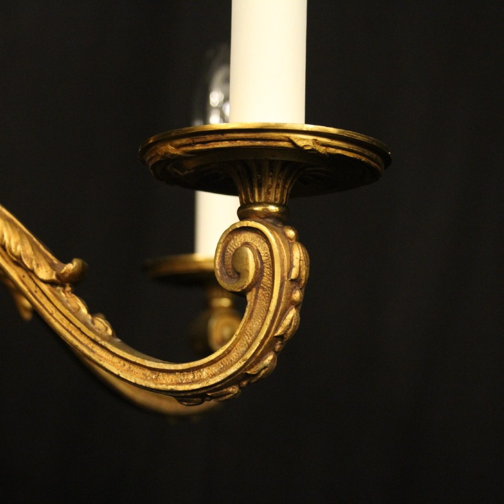 A French six-light chandelier constructed from gilded bronze featuring a fluted central column and scroll-form acanthus arms. View III