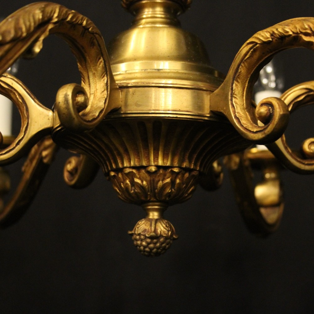A French six-light chandelier constructed from gilded bronze featuring a fluted central column and scroll-form acanthus arms. View V